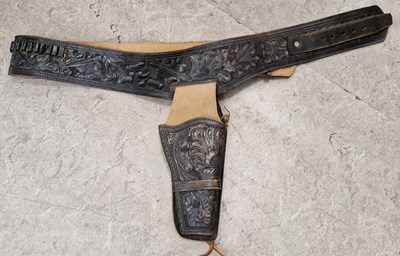 Lot 494 - A 20th century carved leather gun belt/holster...