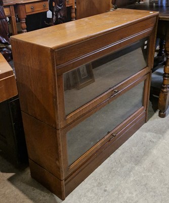 Lot 683 - An early 20th century oak two-sectional...