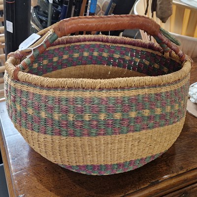 Lot 691 - A vintage wicker basket with leather covered...