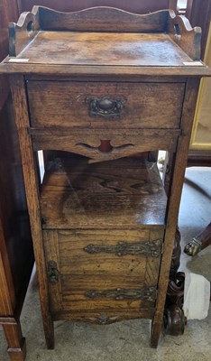 Lot 697 - An oak bedside locker, the rectangular top...