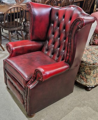 Lot 705 - A burgundy coloured Chesterfield type wing...