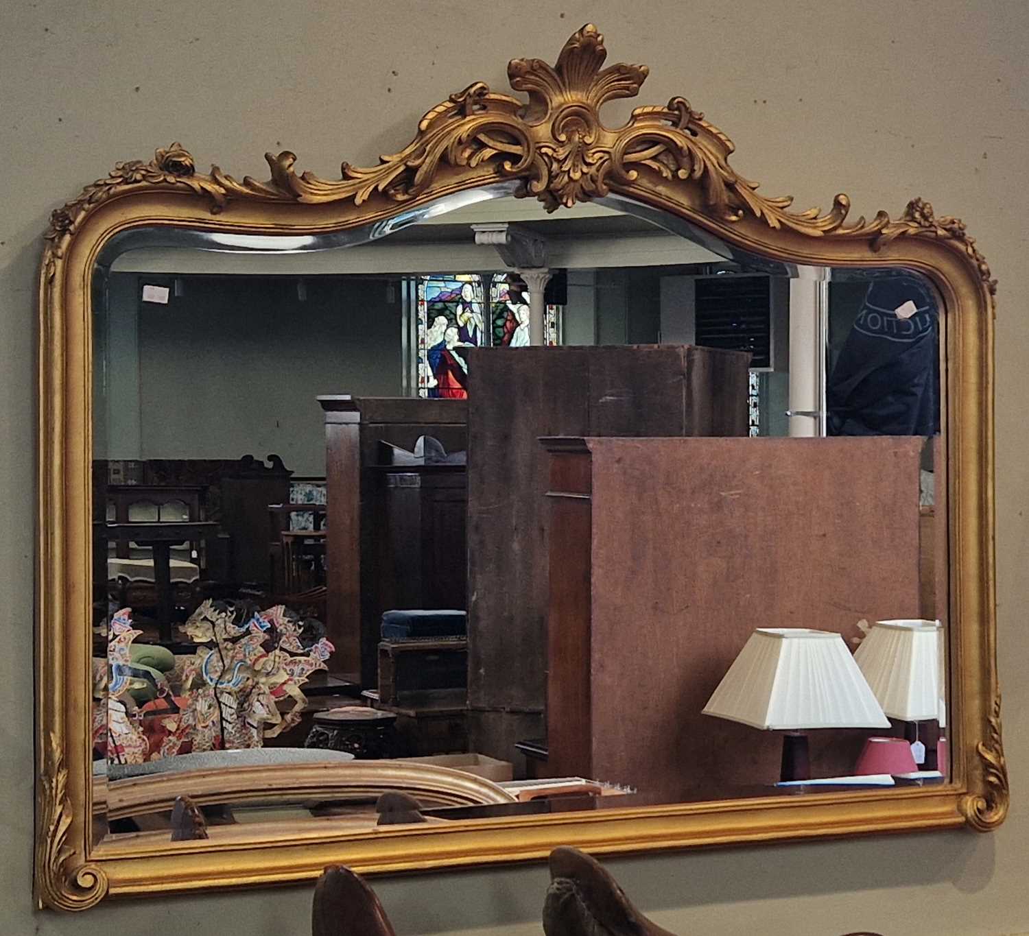Lot 663 - An antique gilt overmantle mirror with...