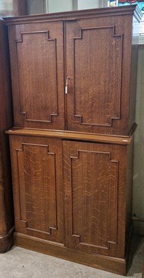 Lot 679 - An early 20th century oak side cupboard, the...