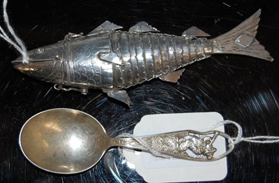 Lot 128 - An articulated white metal fish-shaped scent...