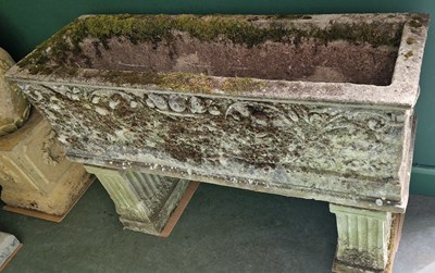 Lot 780 - A reconstituted stone garden trough decorated...