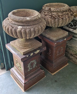 Lot 781 - A pair of reconstituted stone garden urns,...