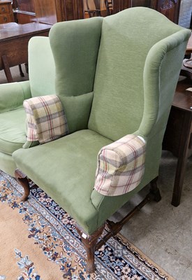 Lot 796 - A green upholstered mahogany wing armchair,...