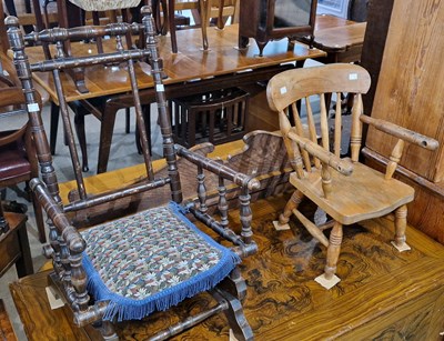 Lot 849 - An antique darkwood childs rocking chair...