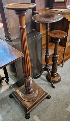 Lot 836 - Three assorted mahogany torcheres, 111cm high,...