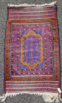 Lot 879 - A Persian saddle cover, worked in blue,...