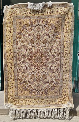 Lot 904 - A 20th century Persian silk rug, worked in...