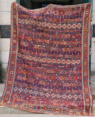 Lot 869 - A Persian flatweave rug, worked in madder,...