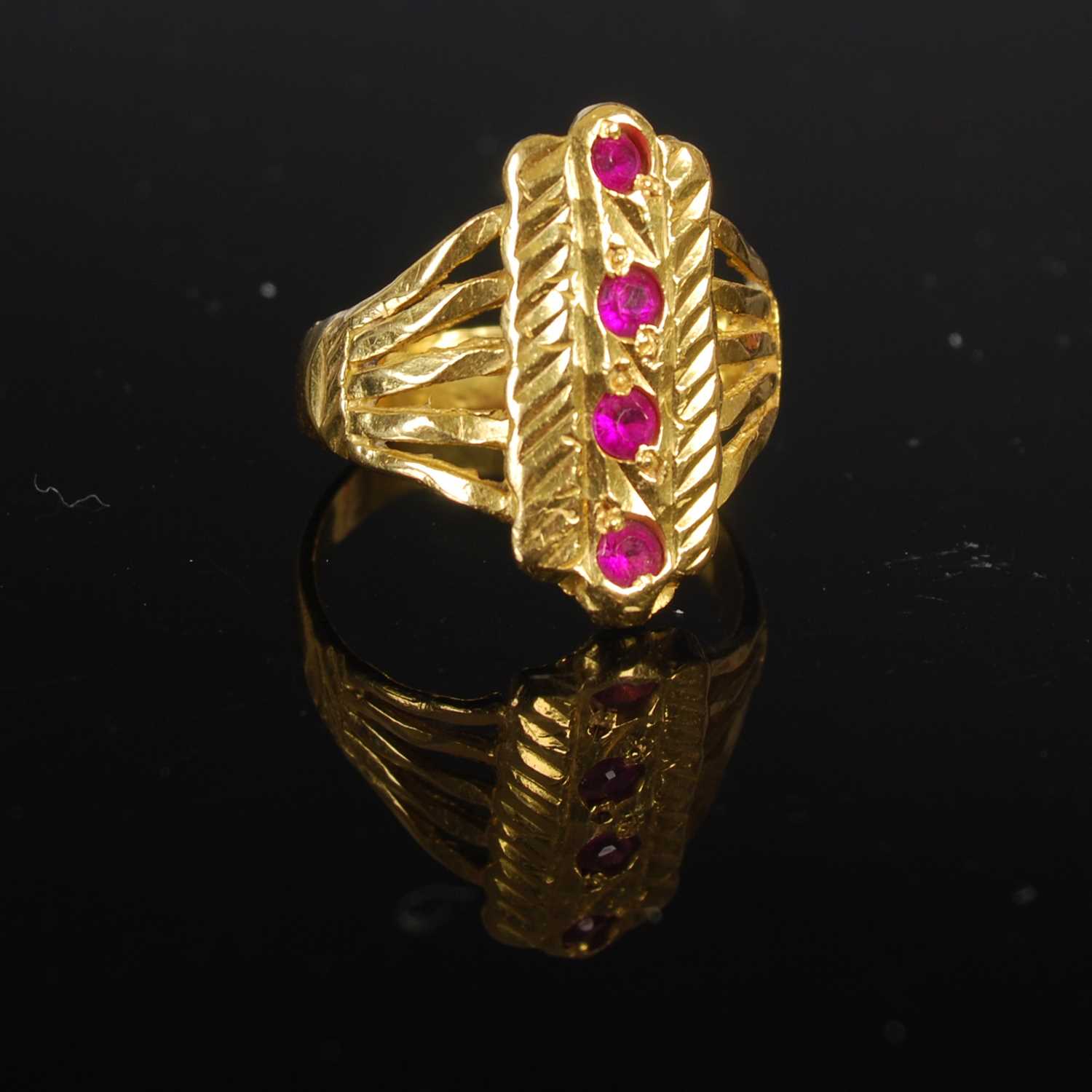 Lot 208 - A 22ct gold and synthetic ruby four stone ring,...