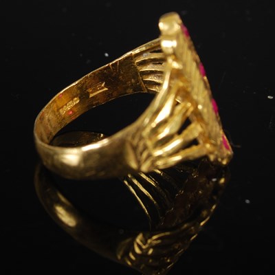 Lot 208 - A 22ct gold and synthetic ruby four stone ring,...