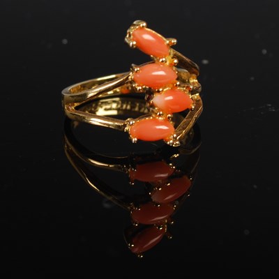 Lot 208H - A yellow metal and coral four stone cabochon...