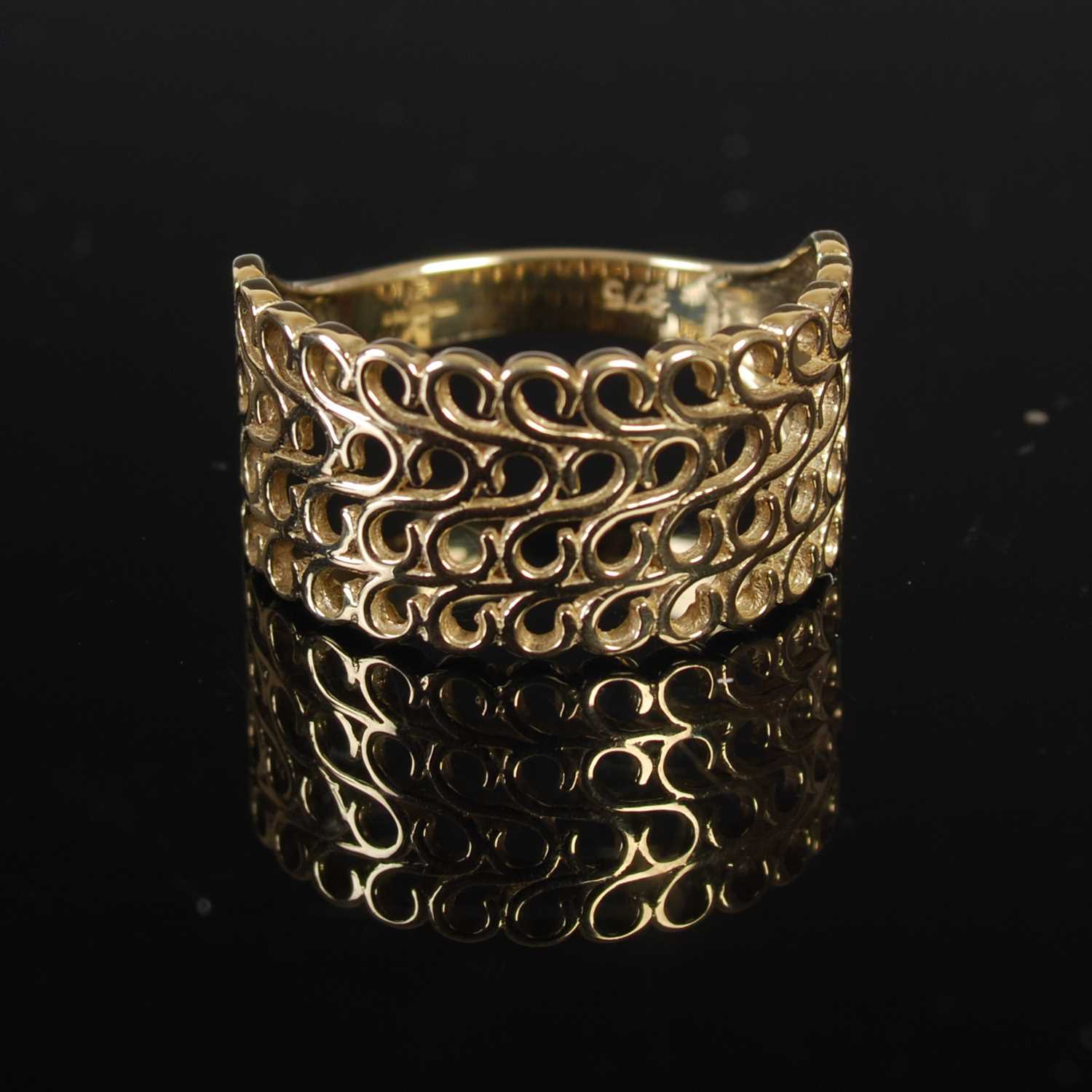 Lot 208 - A 9ct gold four row open work ring, size 'P',