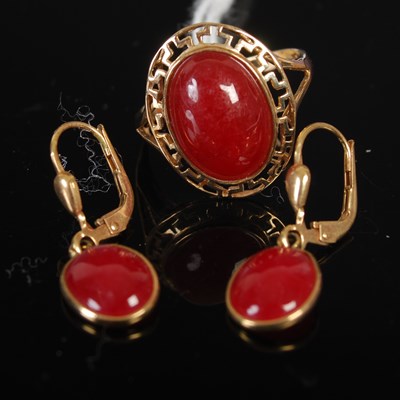Lot 208T - A yellow metal and carnelian cabochon ring...