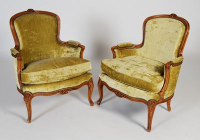 Lot 60 - A pair of 20th century French walnut fauteuils,...