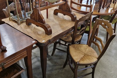 Lot 768 - An early 20th century oak extending dining...