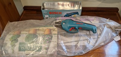 Lot 704 - A Bosch cordless secateur contained within...