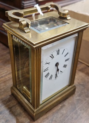 Lot 370 - A brass cased carriage clock with white dial...