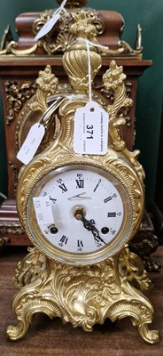 Lot 371 - A gilt metal mantle clock, the white enamelled...