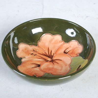 Lot 33 - A Moorcroft pottery green ground footed dish,...