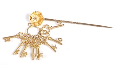 Lot 56 - A yellow metal and diamond chip stick pin...