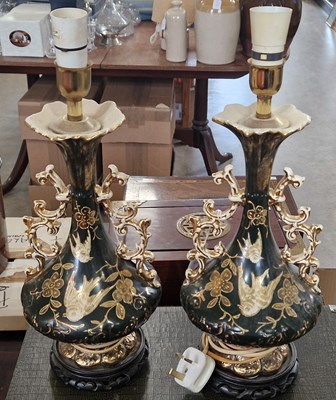 Lot 493 - A pair of porcelain twin-handled vases mounted...