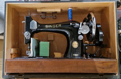 Lot 494 - A 20th century cased Singer sewing machine...