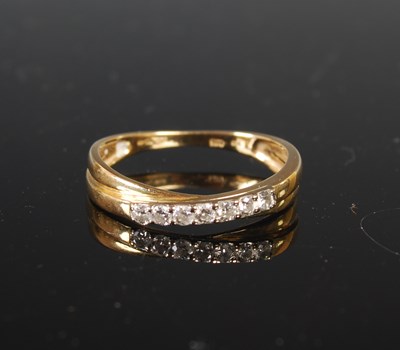 Lot 69 - An 18ct gold and diamond seven-stone ring,...