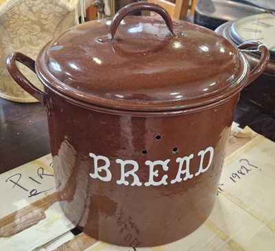 Lot 524 - A brown enamelled twin-handled bread bin and...