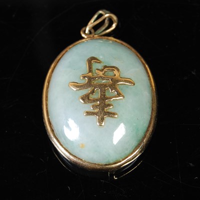 Lot 78 - A Chinese yellow metal mounted oval jade...