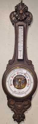 Lot 702 - An Antique carved oak Aneroid barometer by...