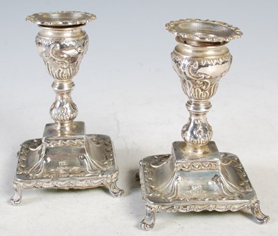 Lot 135 - A pair of Sheffield silver candlesticks with...