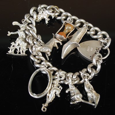 Lot 263 - A silver charm bracelet suspending ten...