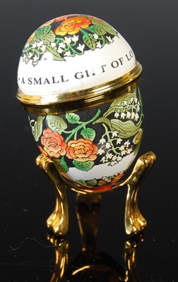 Lot 268 - A boxed Halcyon Days enamel egg-shaped box...