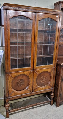 Lot 760 - An early 20th century oak bookcase, with two...