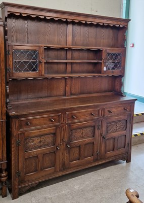 Lot 761 - A 20th century oak Old Charm style dining room...