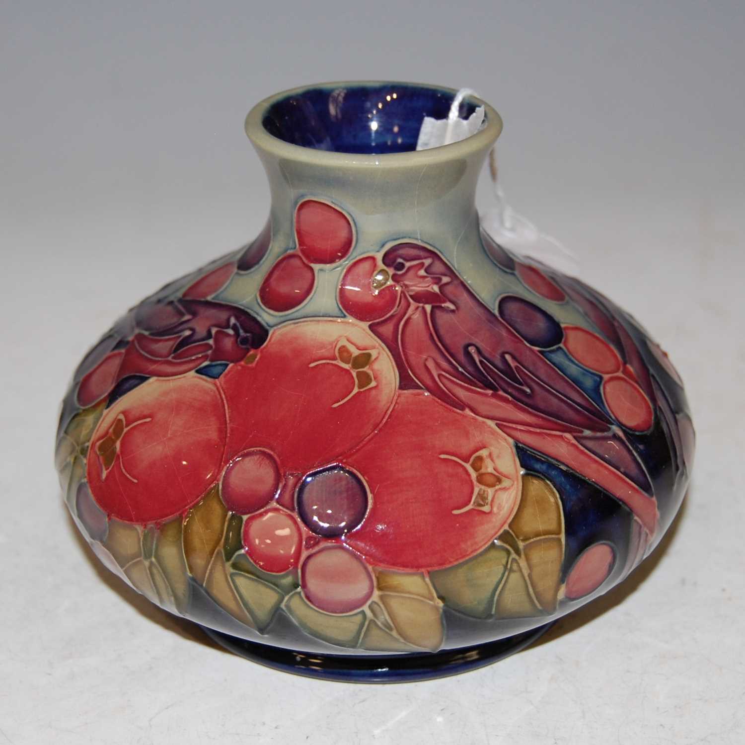 Lot 199 - A Moorcroft pottery blue ground vase, finches...