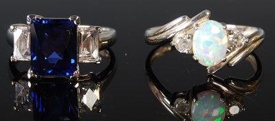 Lot 304 - Two white metal dress rings to include an opal...