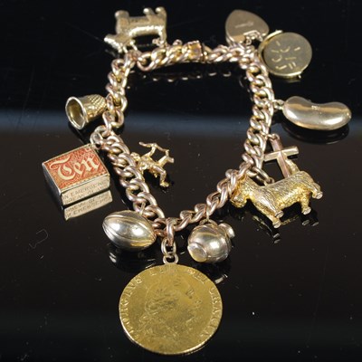 Lot 314 - A yellow metal charm bracelet, stamped '9ct',...