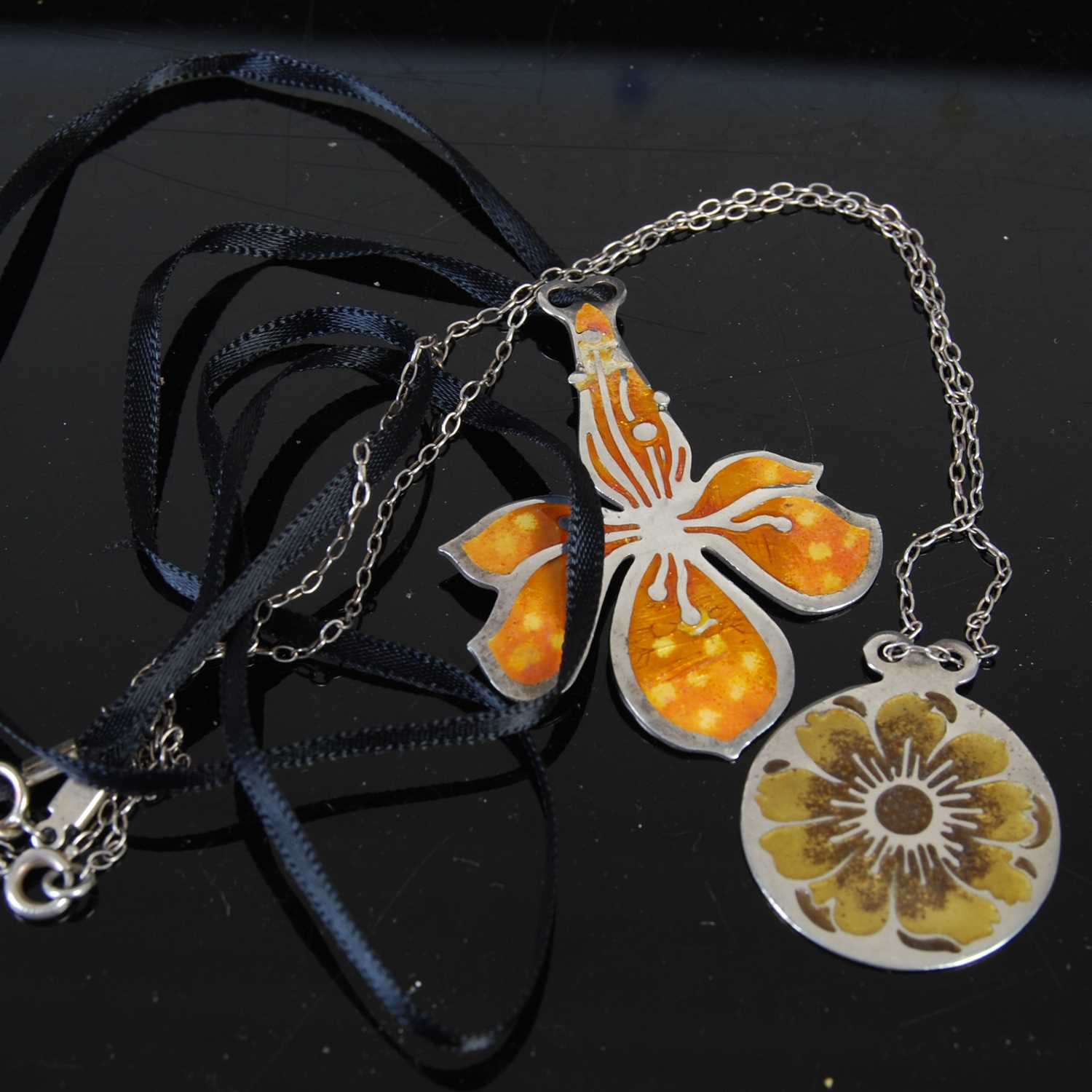 Lot 122 - Two Norman Grant silver and enamel pendants...