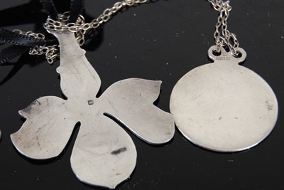 Lot 122 - Two Norman Grant silver and enamel pendants...