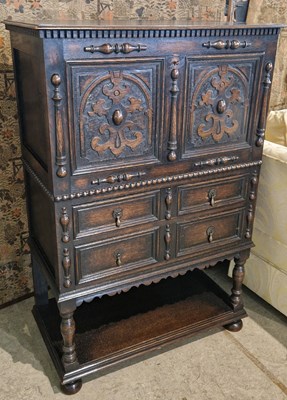 Lot 882 - A stained oak writing cabinet, the rectangular...