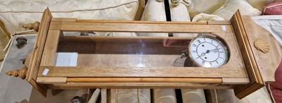 Lot 880 - A 20th century blonde wood wall clock the...