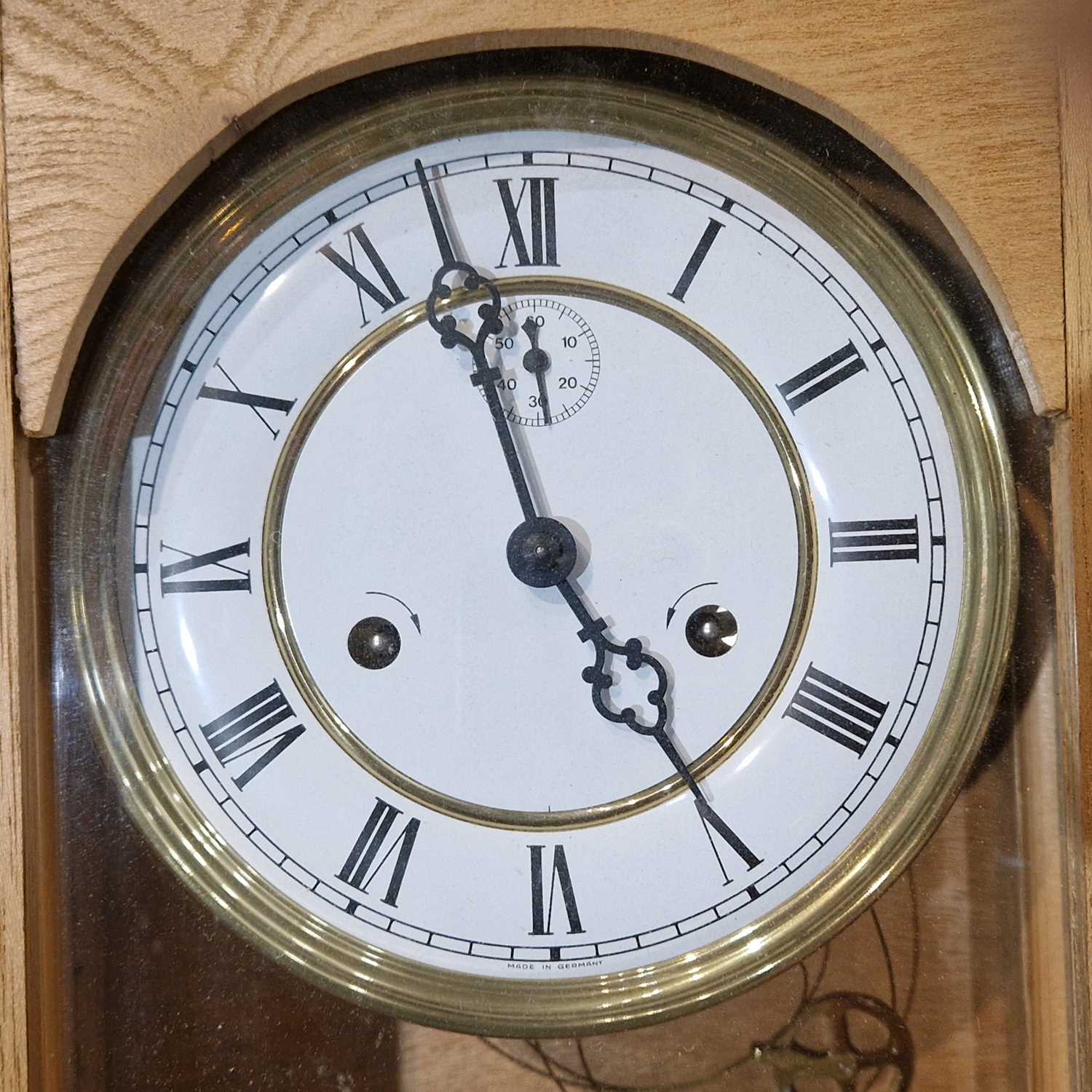 Lot 880 - A 20th century blonde wood wall clock the