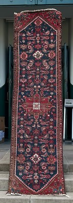 Lot 912 - A 20th century Persian runner, the blue ground...