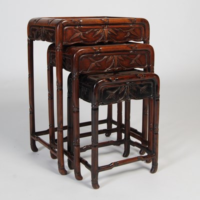 Lot 65 - A nest of three Chinese darkwood occasional...