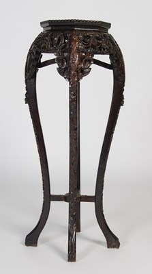 Lot 40 - A Chinese darkwood urn stand, the...